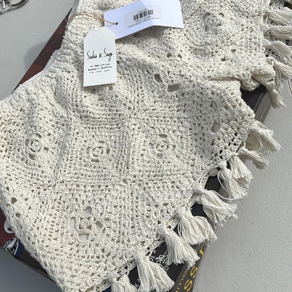 New with tags. Crochet fringe shorts. Size small. Cream color.